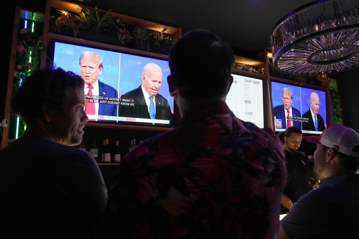 Patrons watch President Biden debate former President Trump at a watch party in Scottsdale, Ariz.