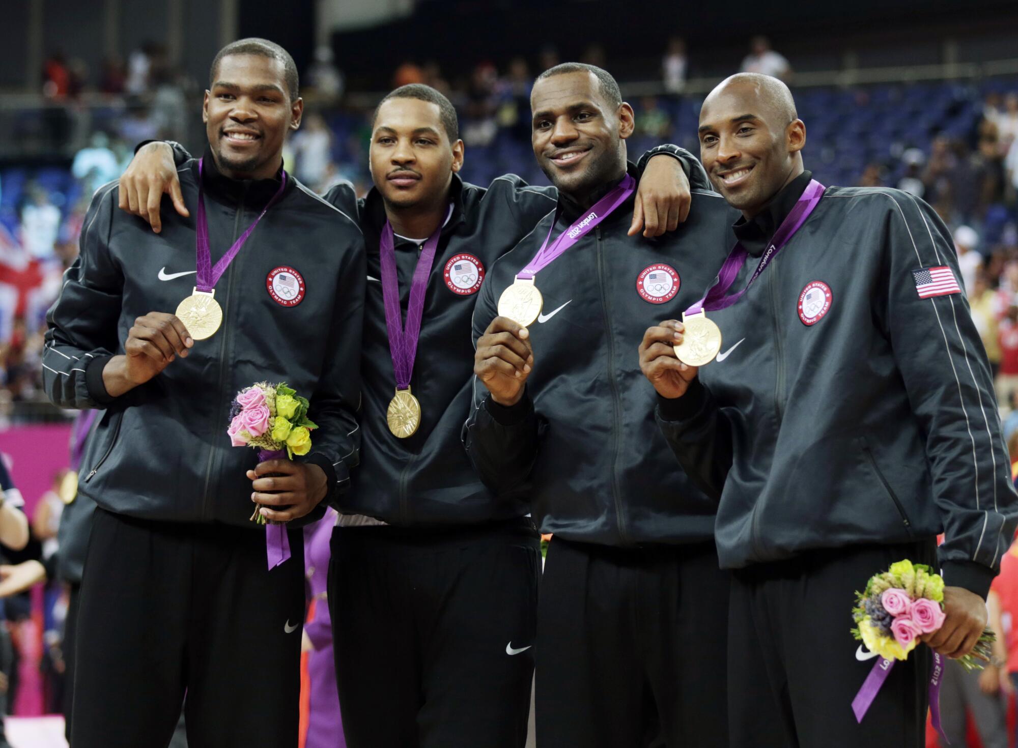 Team USA members (from left) Kevin Durant, Carmelo Anthony, LeBron James and Kobe Bryant show off their gold medals in 2012.