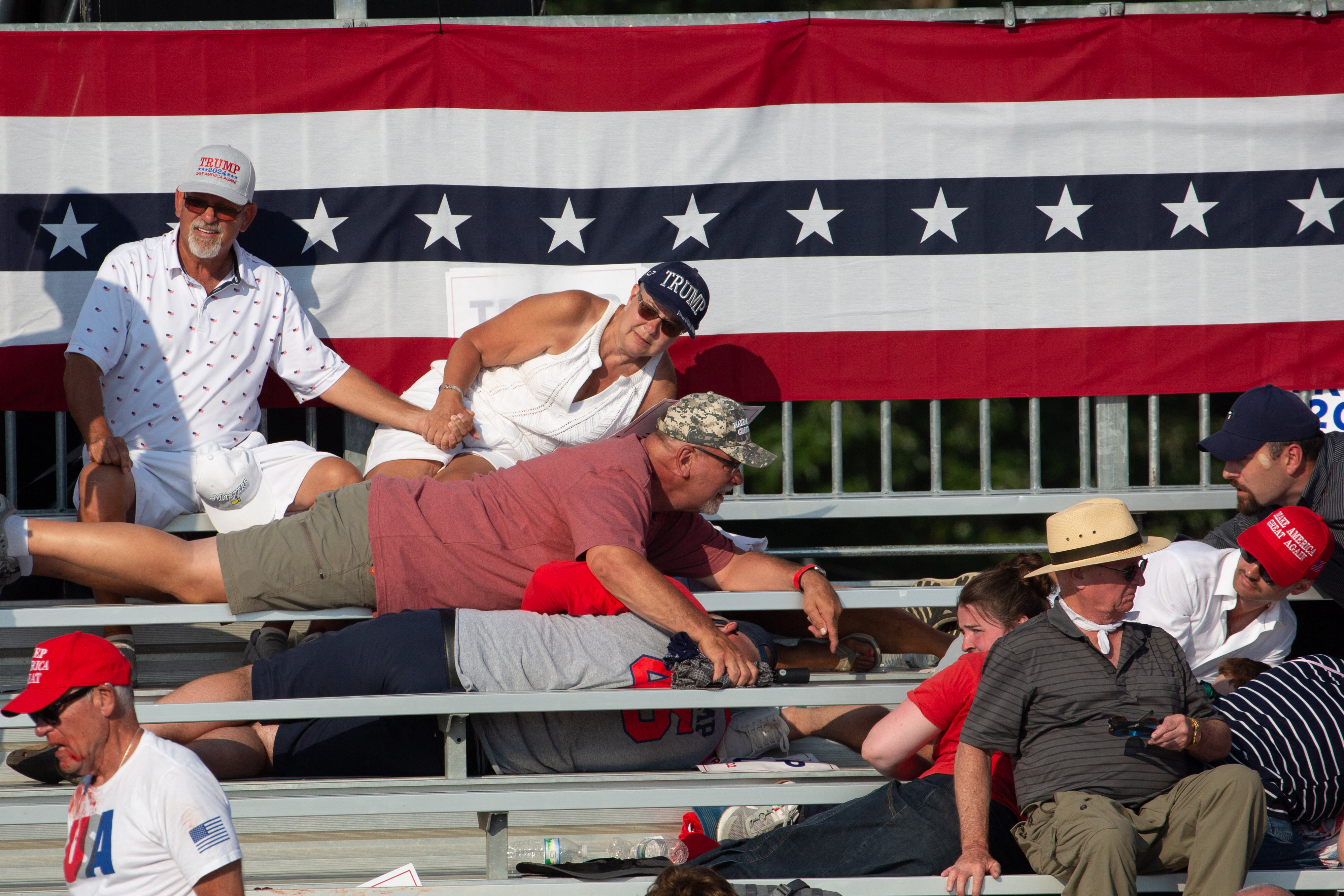 Supporters were seen lying in the stands after gunfire erupted