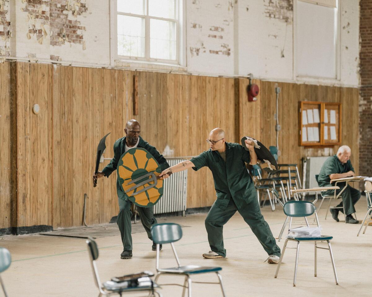 Two men playing with prop swords and shields