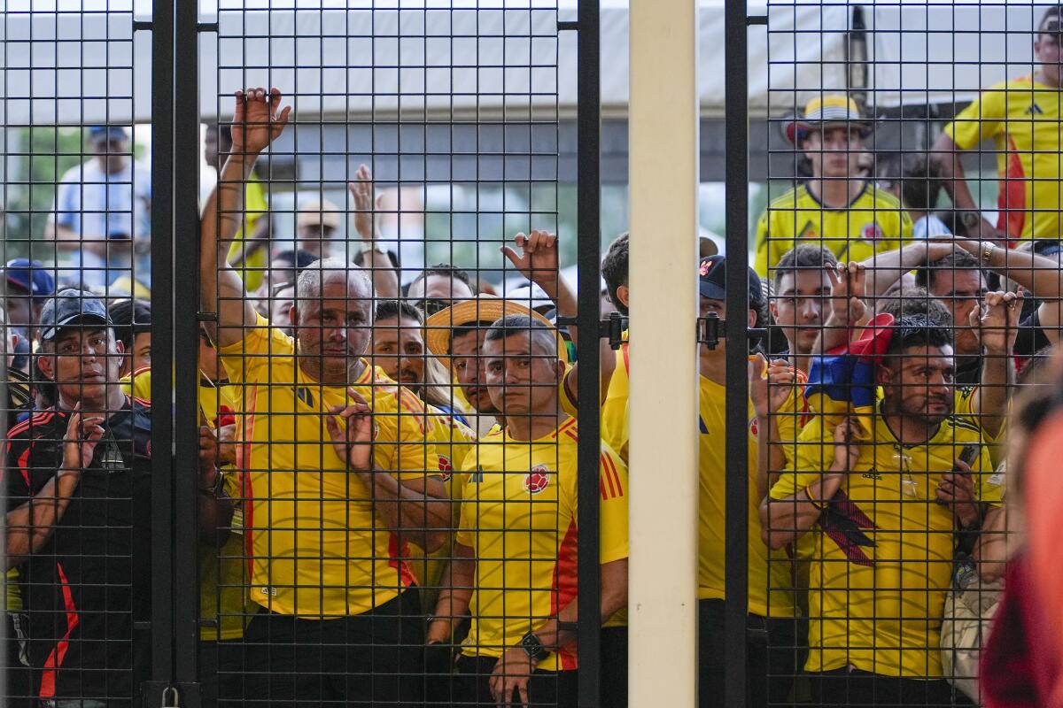 Fans wait for gates to open at Hard Rock Stadium before Sunday's game.