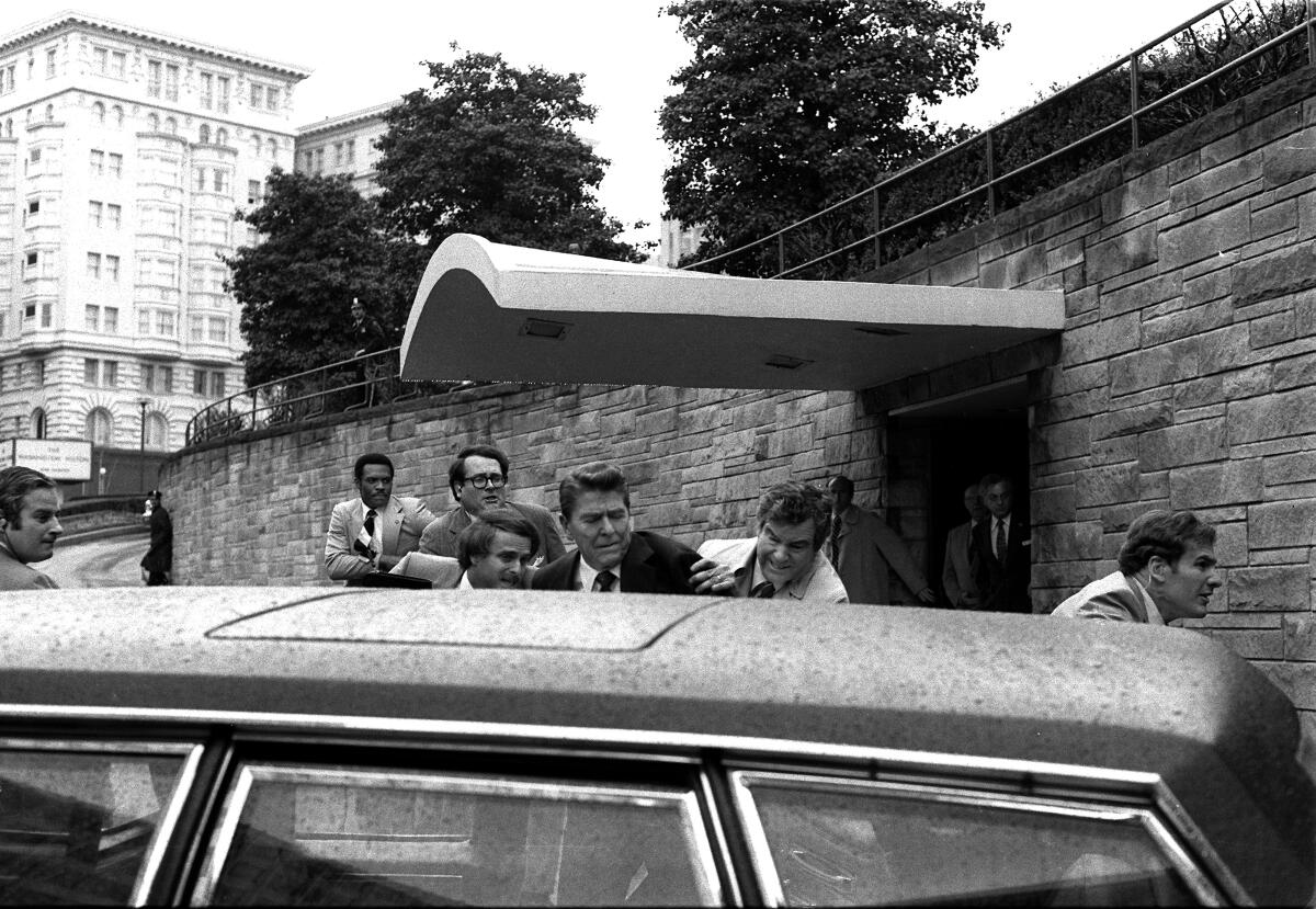 President Reagan is shoved into his limousine after being shot outside a hotel in 1981.