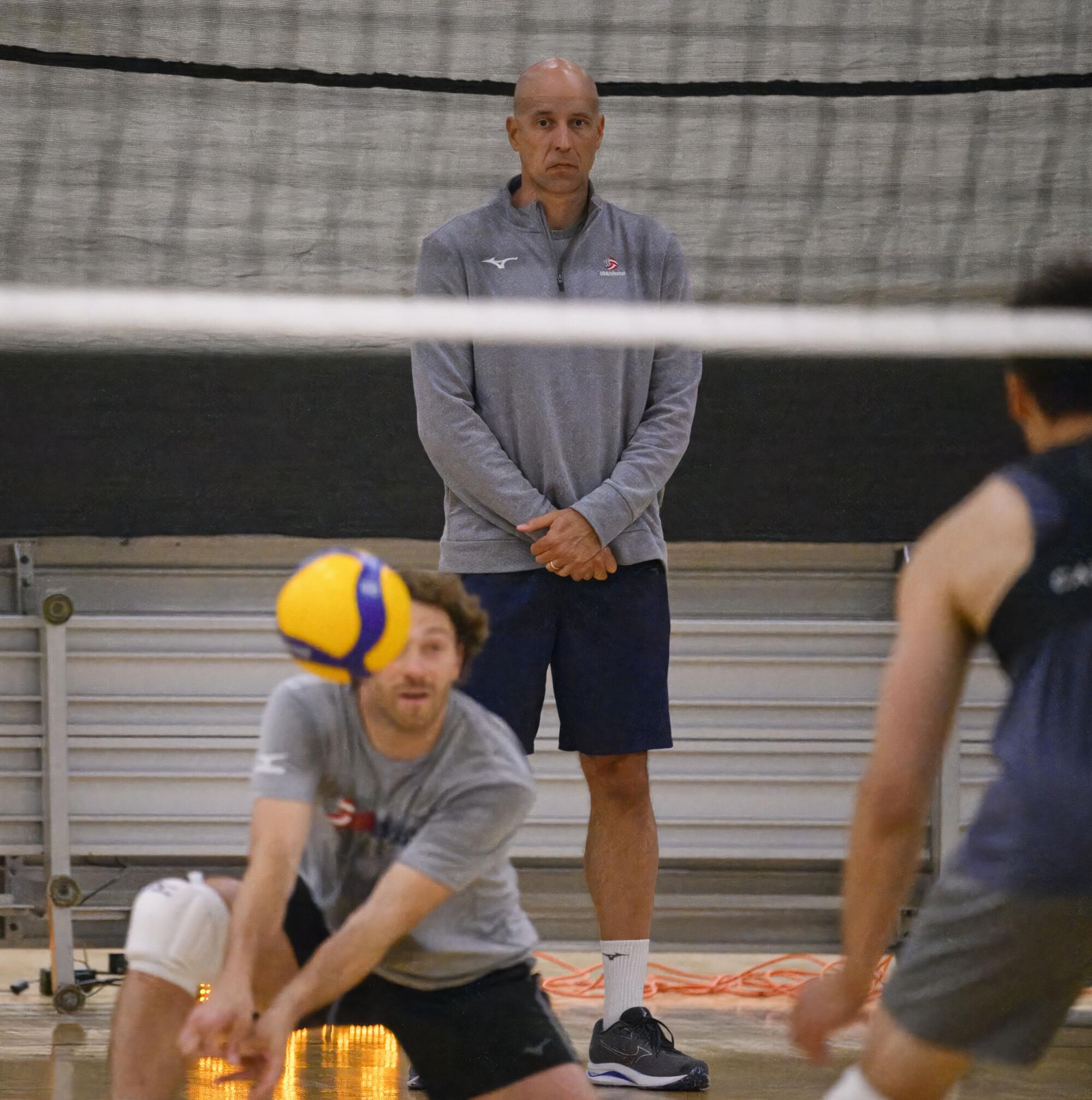 John Speraw, center, watches as his players practice.