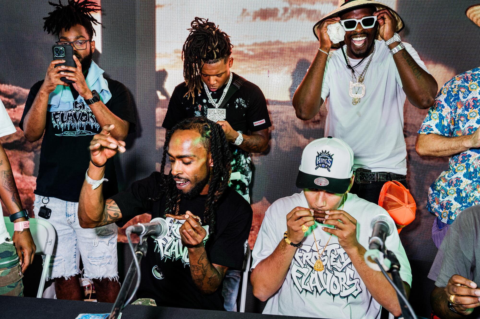 A group of people smoking and celebrating on stage.