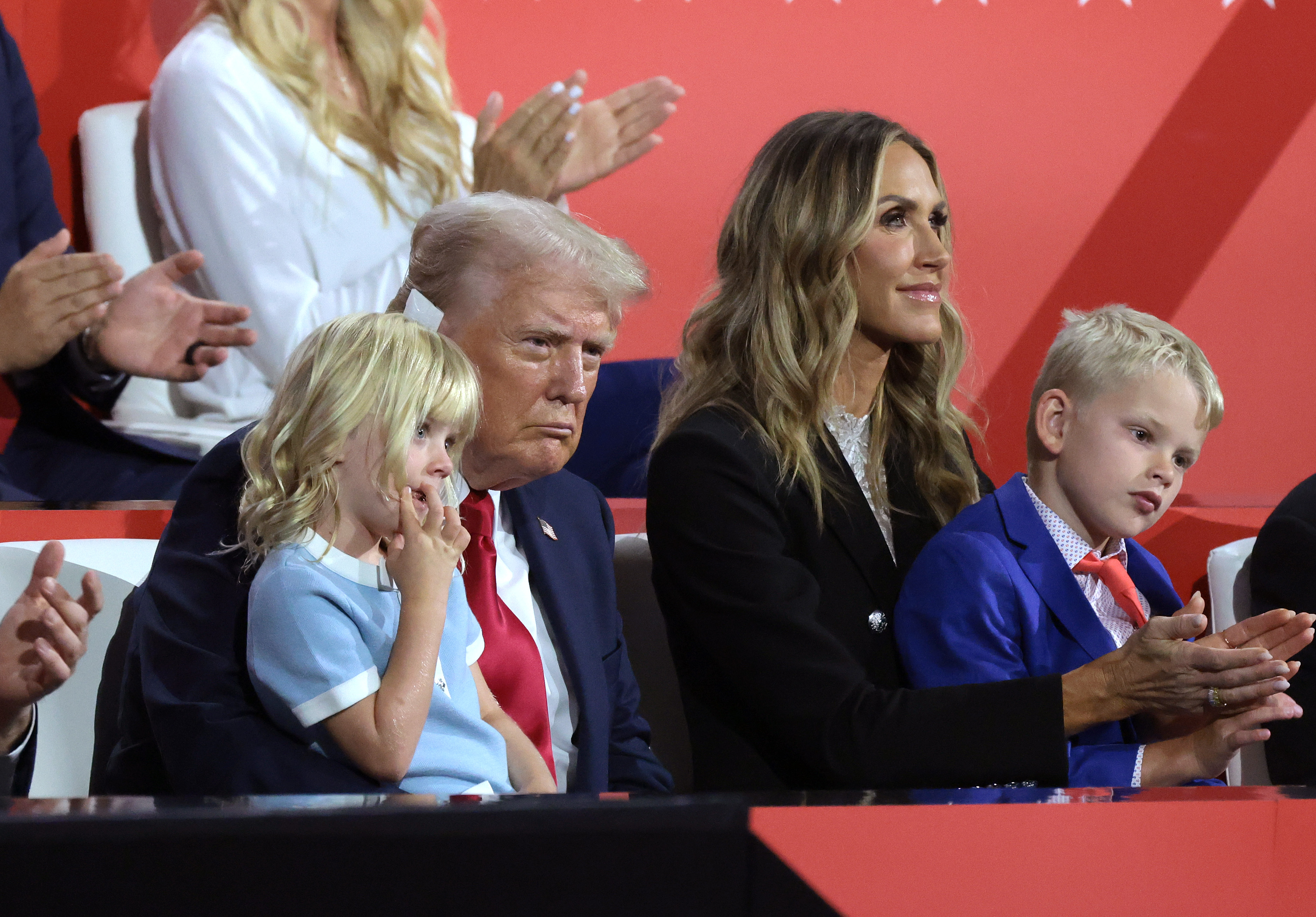 Republican presidential candidate, former U.S. President Donald Trump sits with Republican National Committee co-chair Lara Trump and his grandchildren on the fourth day of the Republican National Convention