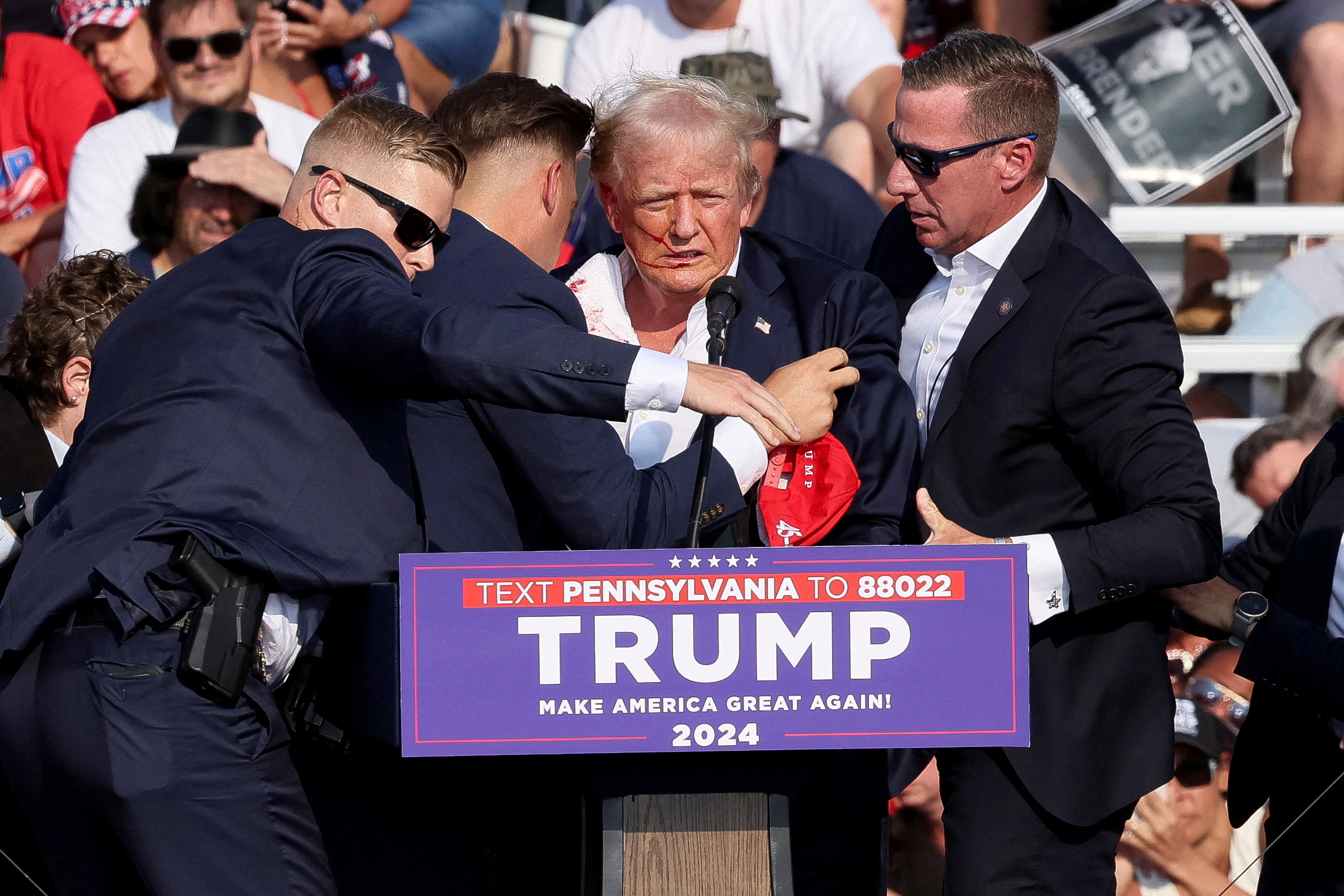 Former President Trump was seen swarmed by Secret Service agents after shots were fired by Crooks at the stage