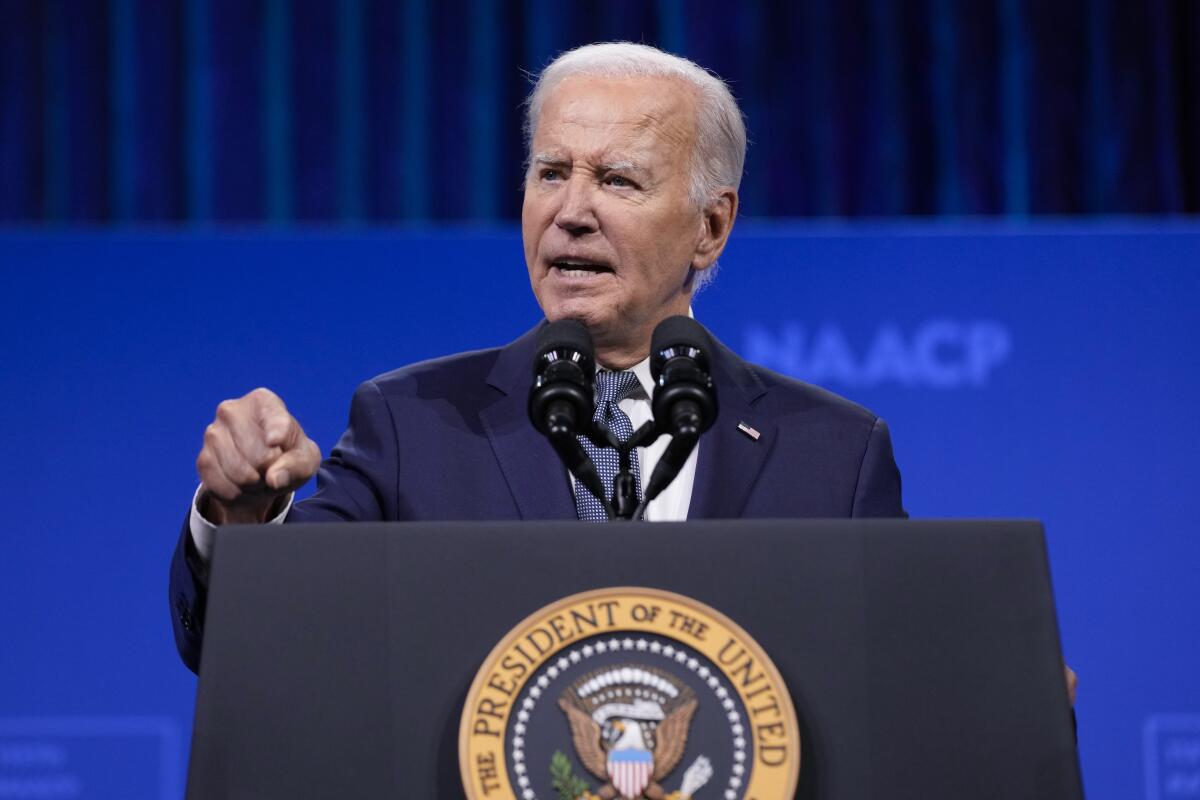 President Biden speaks at a lectern.