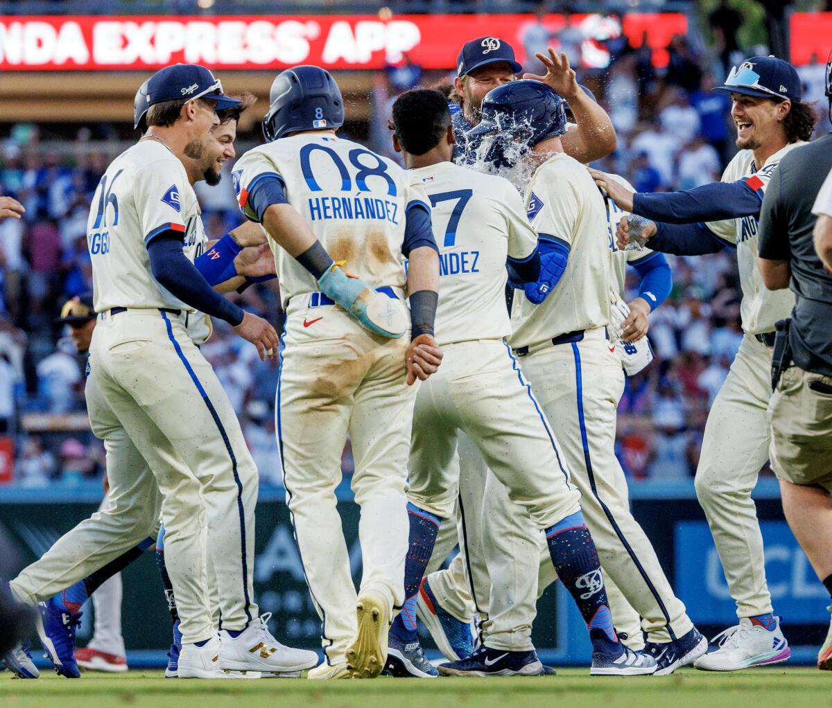 Dodgers catcher Will Smith gets a face full of water as he celebrates with teammates after hitting a walk-off single.