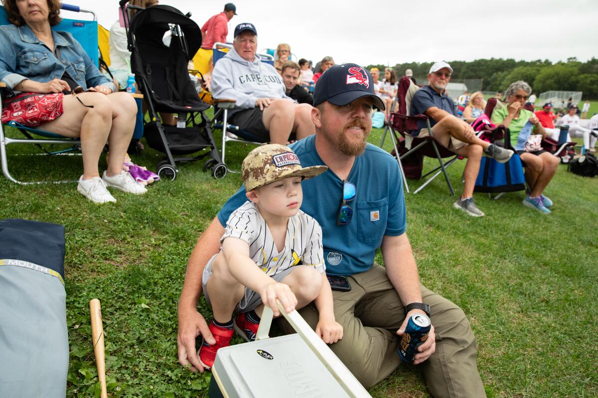 Fans line the outfield while they watch the Yarmouth-Dennis Red Sox take on Orleans earlier this month.