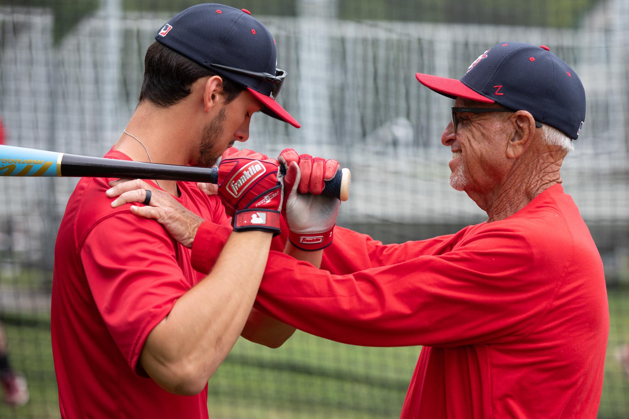 Coach Scott Pickler, right, works with Will Tippett. 