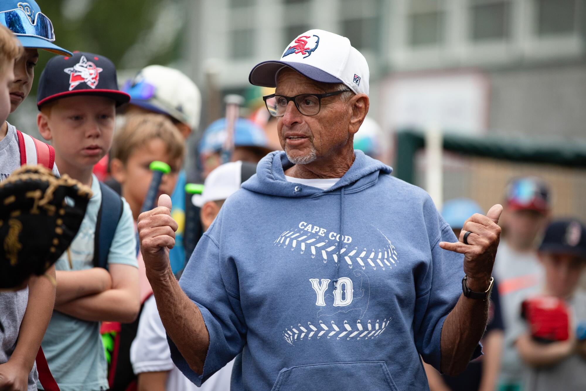 Coach Scott Pickler talks to young baseball players. 