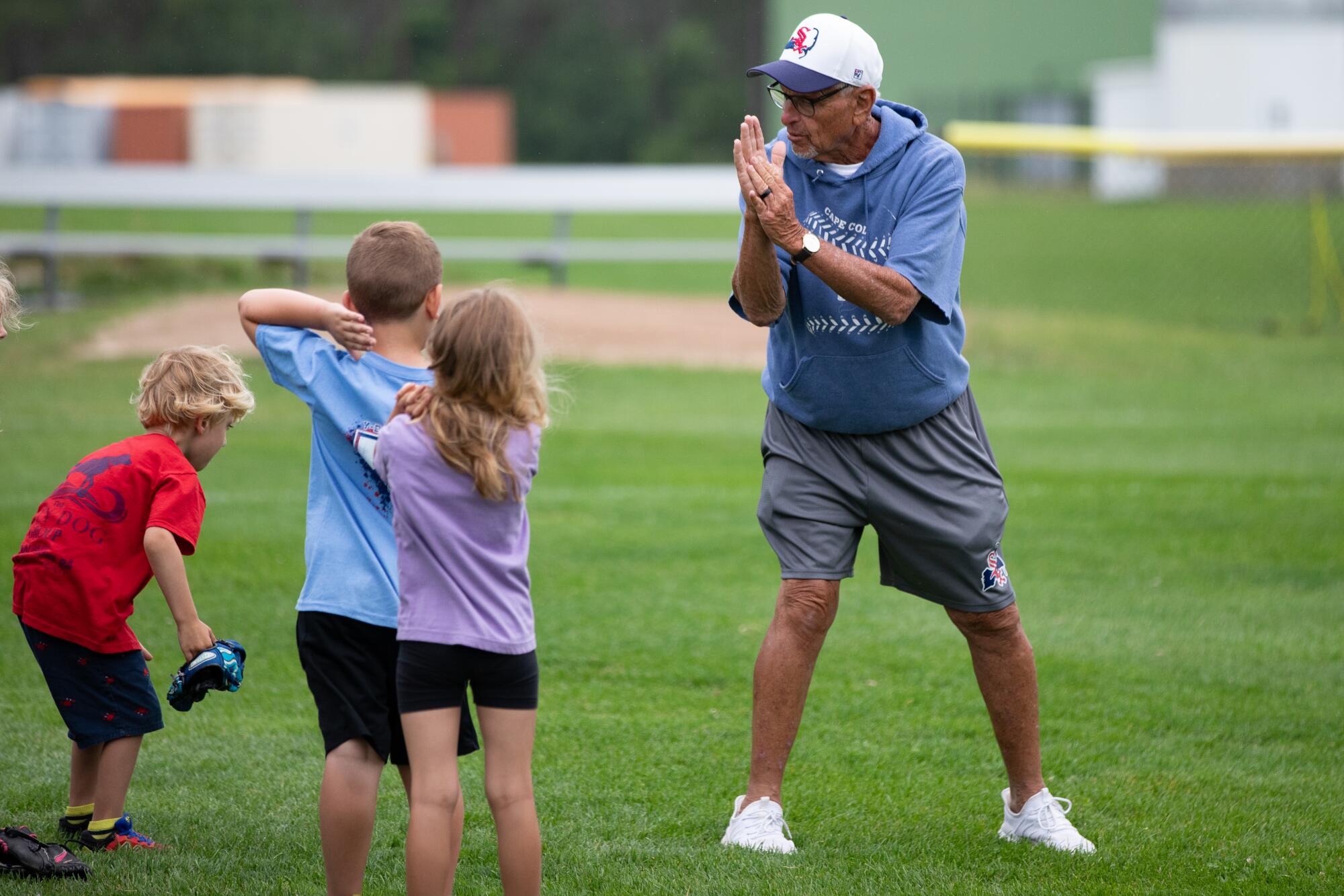 Coach Scott Pickler talks to young baseball players. 