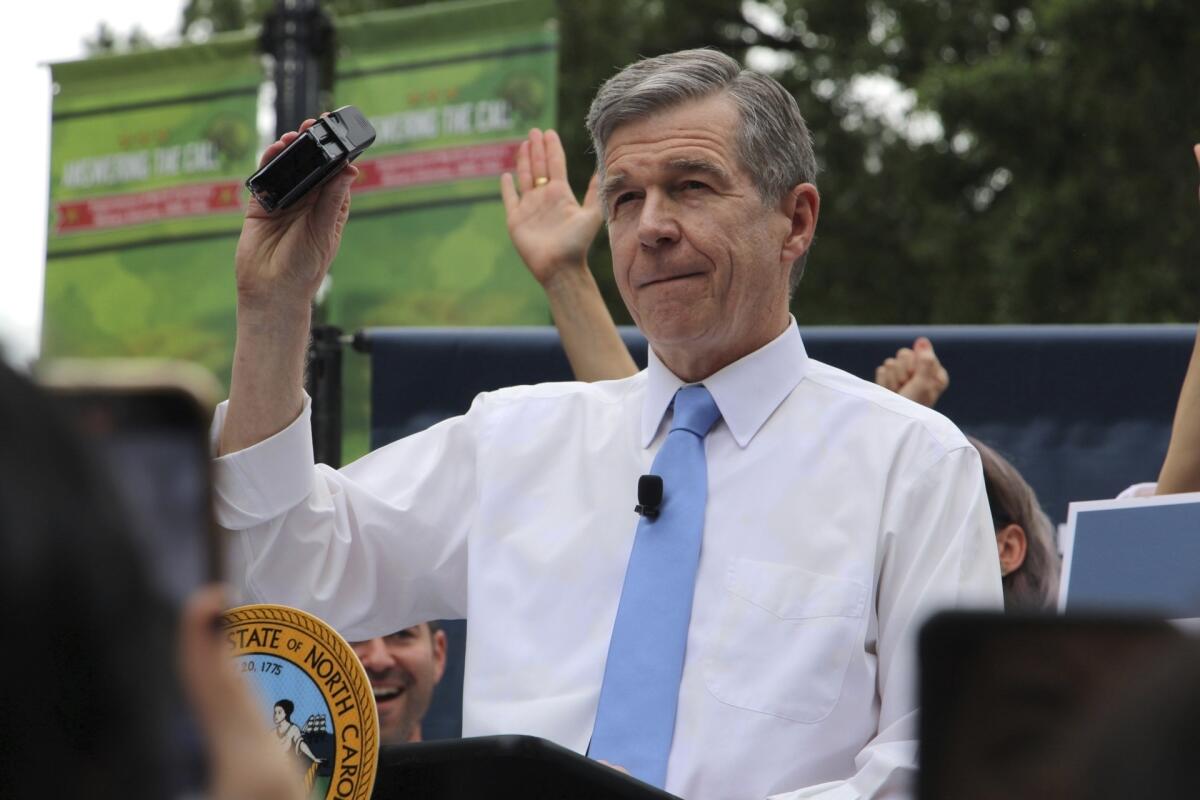 North Carolina Democratic Gov. Roy Cooper holding a veto stamp