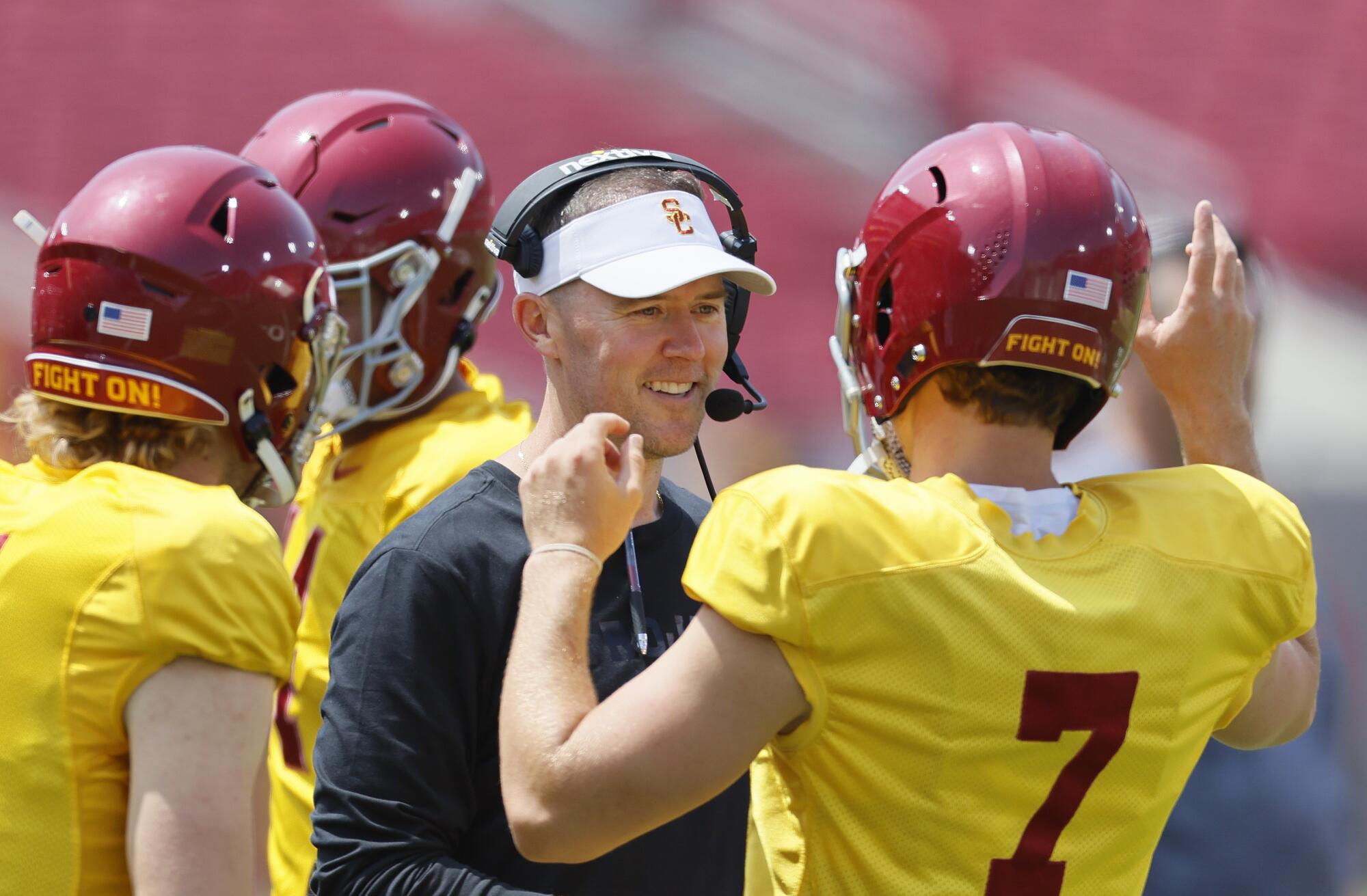 USC coach Lincoln Riley talks to quarterback Miller Moss during USC's spring game at the Coliseum in April.