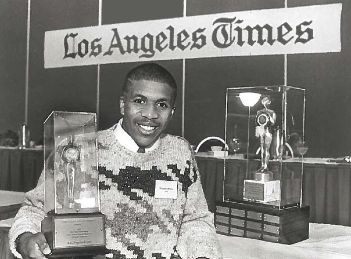 Crespi running back Russell White holding the Glenn Davis trophy.