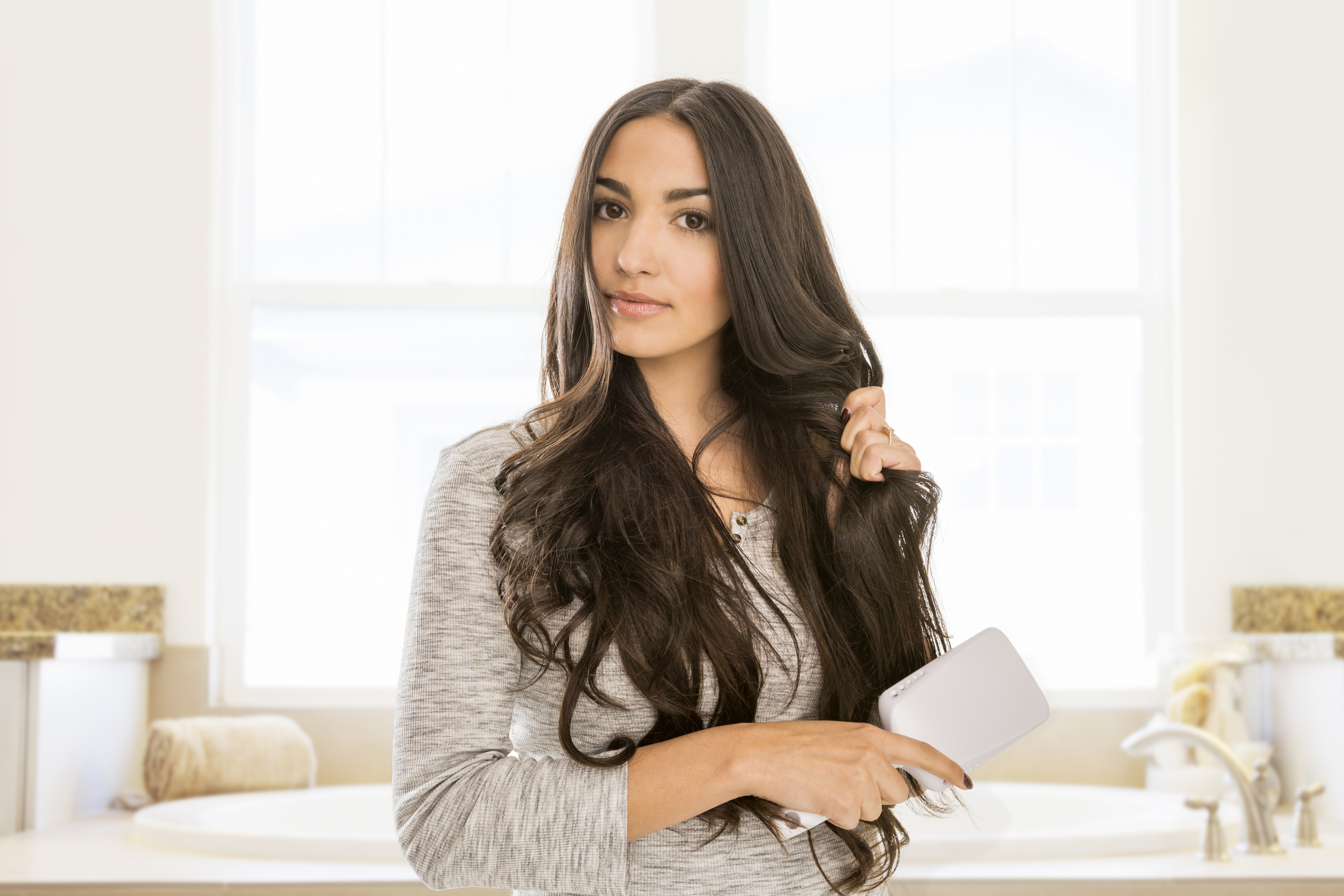 Karelina said it's best to embrace your natural hair texture to avoid damaging tresses (stock image)