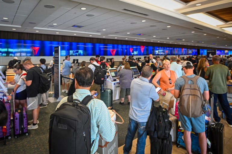 ORLANDO, FLORIDA - JULY 19: Passengers wait on long queues at check-in counters due to the global communications outage caused by CrowdStrike at Orlando International Airport on July 19, 2024, in Orlando, Florida. Businesses and airlines worldwide continue to be affected by a global technology outage attributed to a software update administered by CrowdStrike, a cybersecurity firm whose software is used by various industries around the world. Miguel J. Rodriguez Carrillo/Getty Images/AFP (Photo by Miguel J. Rodriguez Carrillo / GETTY IMAGES NORTH AMERICA / Getty Images via AFP)