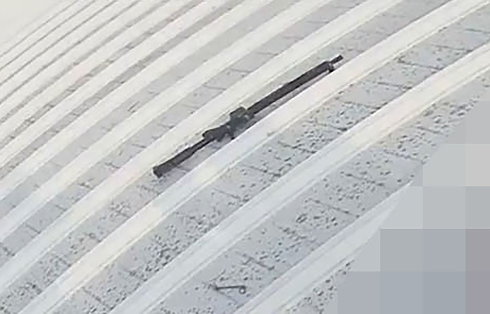 The rifle used in the shooting was lying next to his body on the roof