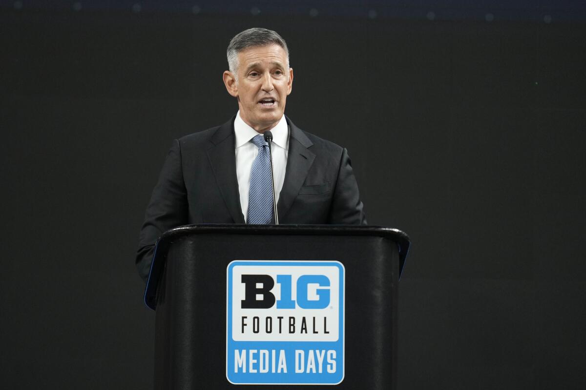 Big Ten commissioner Tony Petitti stands at a podium and speaks during a Big Ten Conference media days news conference 