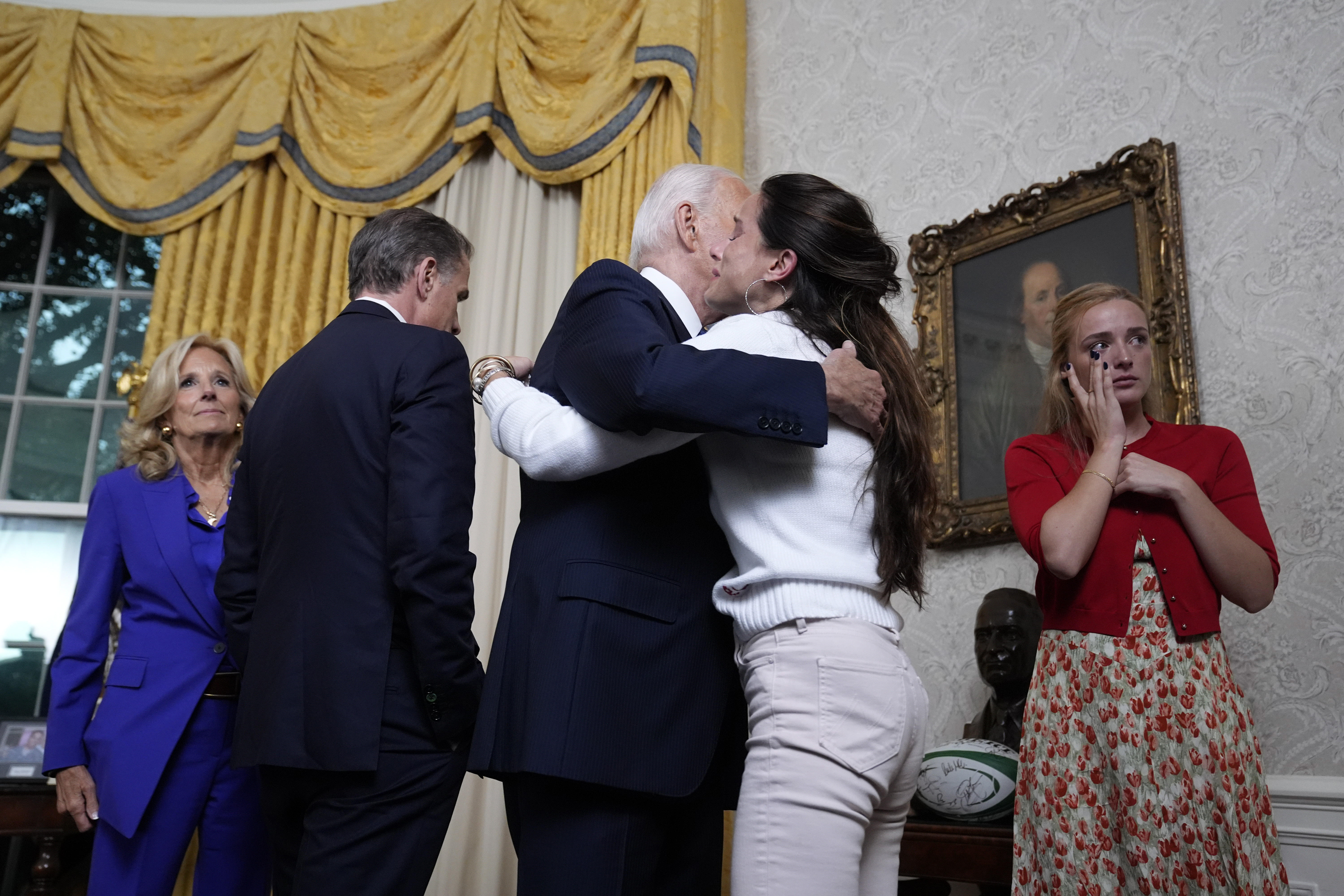 Biden hugging his daughter, Ashley Biden, as his granddaughter, son, and wife stand on the side