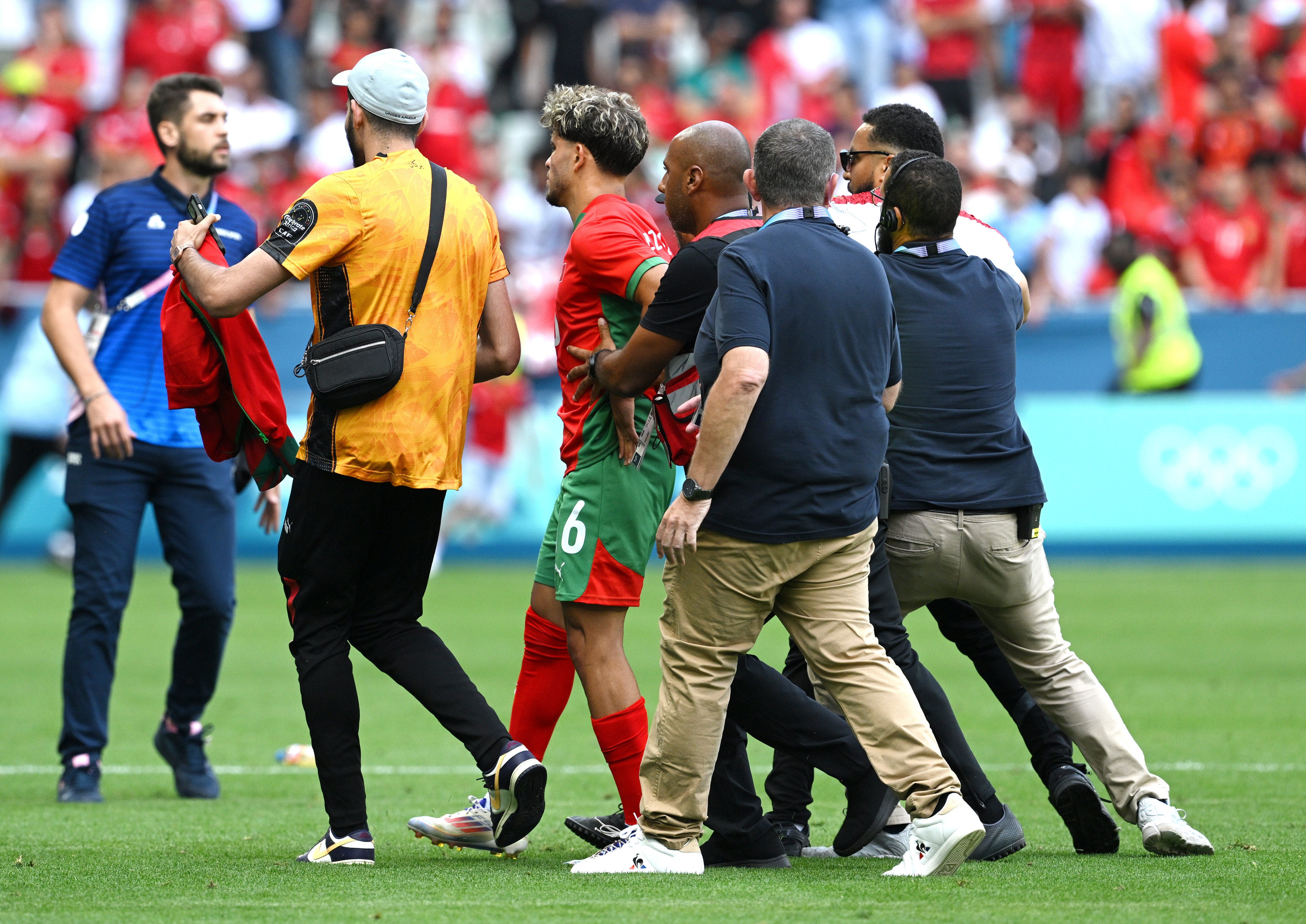 Moroccan stars were also escorted to safety having thought the game was OVER