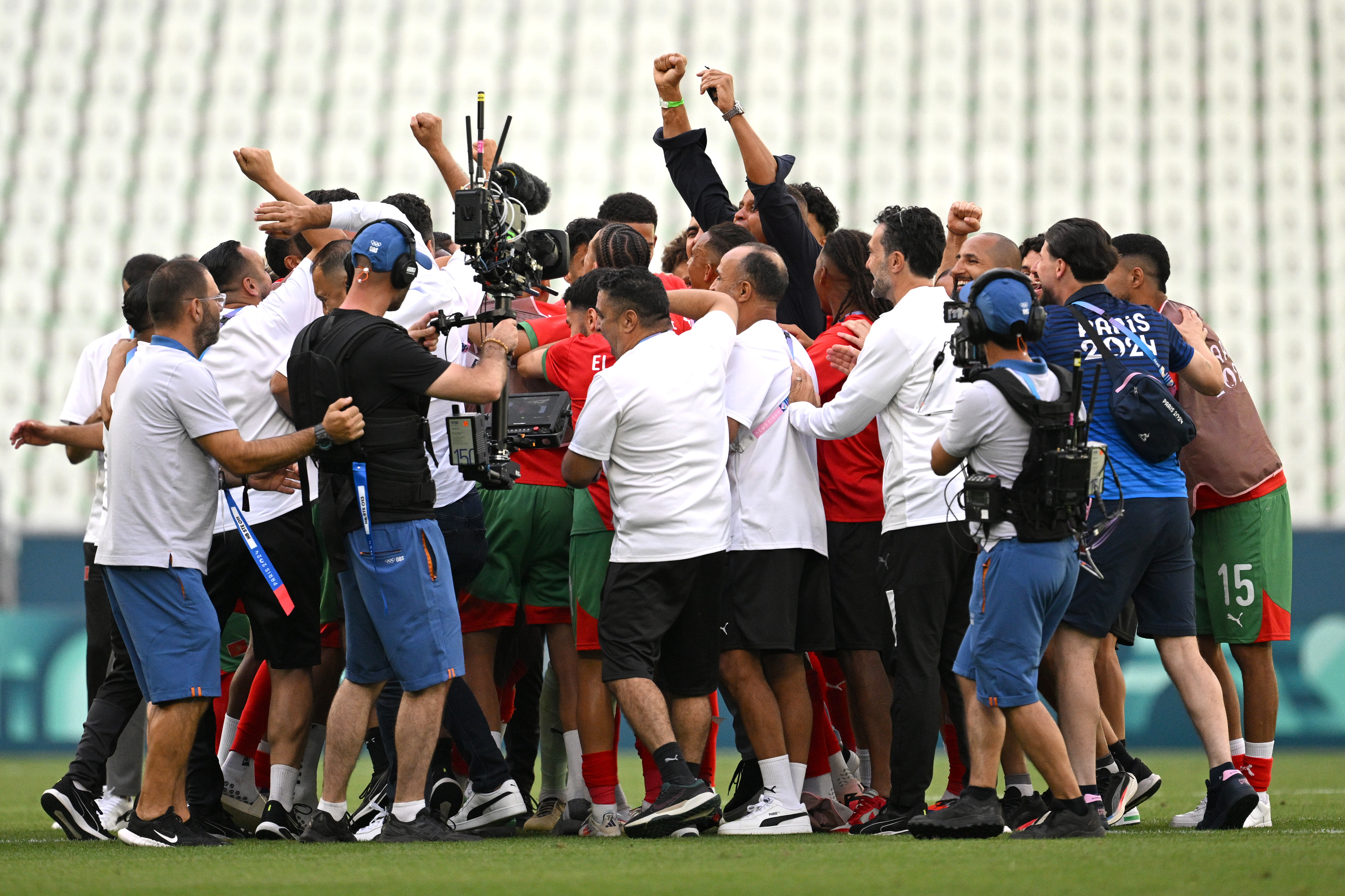 Morocco celebrate following the team’s 2-1 victory to finally end the four-hour ordeal