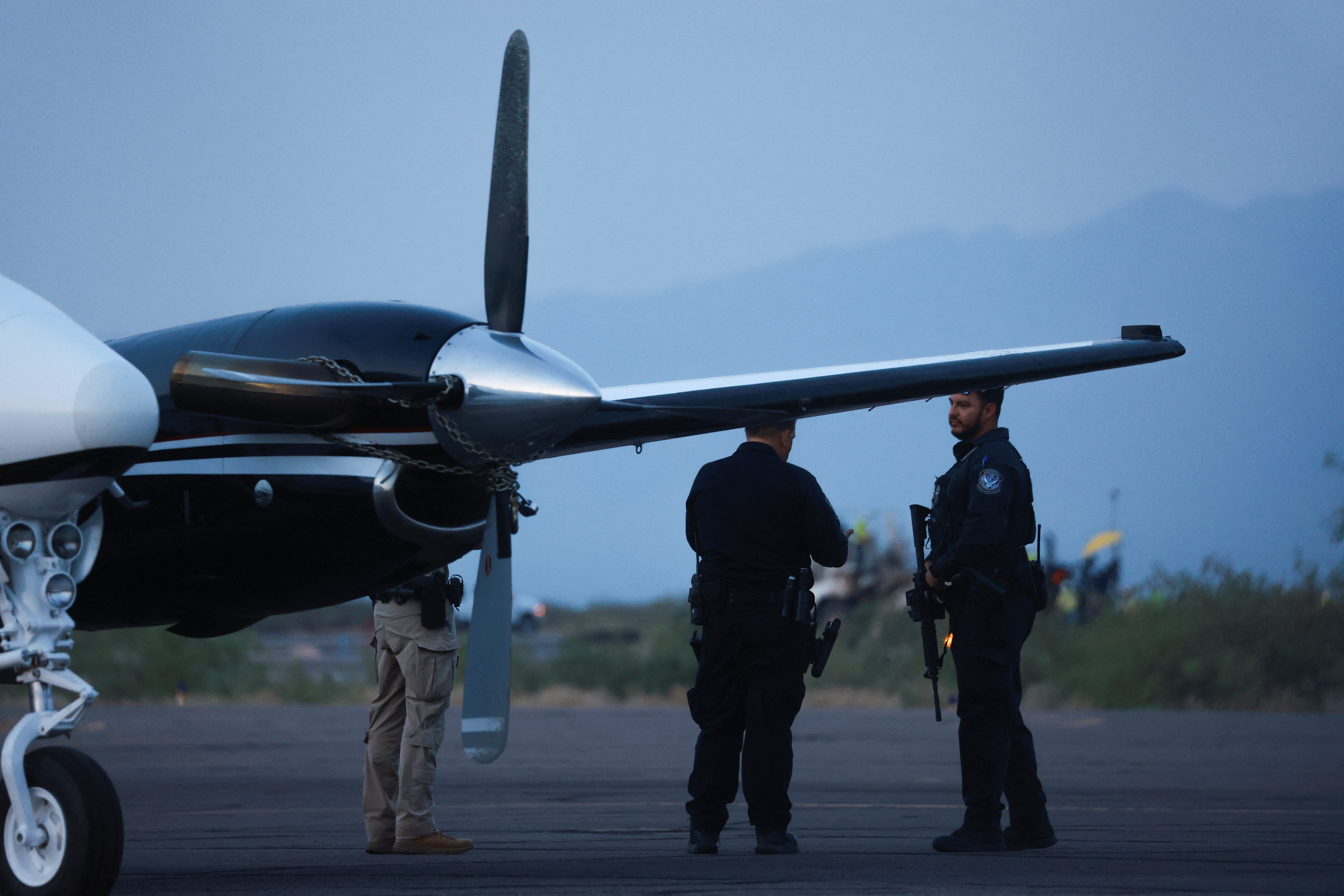 Federal agents stand by a plane believed to be carrying Mexican drug lords Ismael 'El Mayo' Zambada and Joaquin Guzman Lopez, the son of, Joaquin 'El Chapo' Guzman, who were both arrested in El Paso, Texas