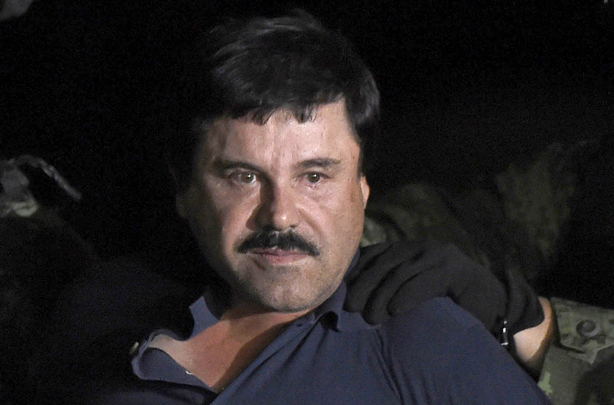 Drug kingpin Joaquin “El Chapo” Guzman being escorted into a helicopter at Mexico City’s airport in 2016 following his capture