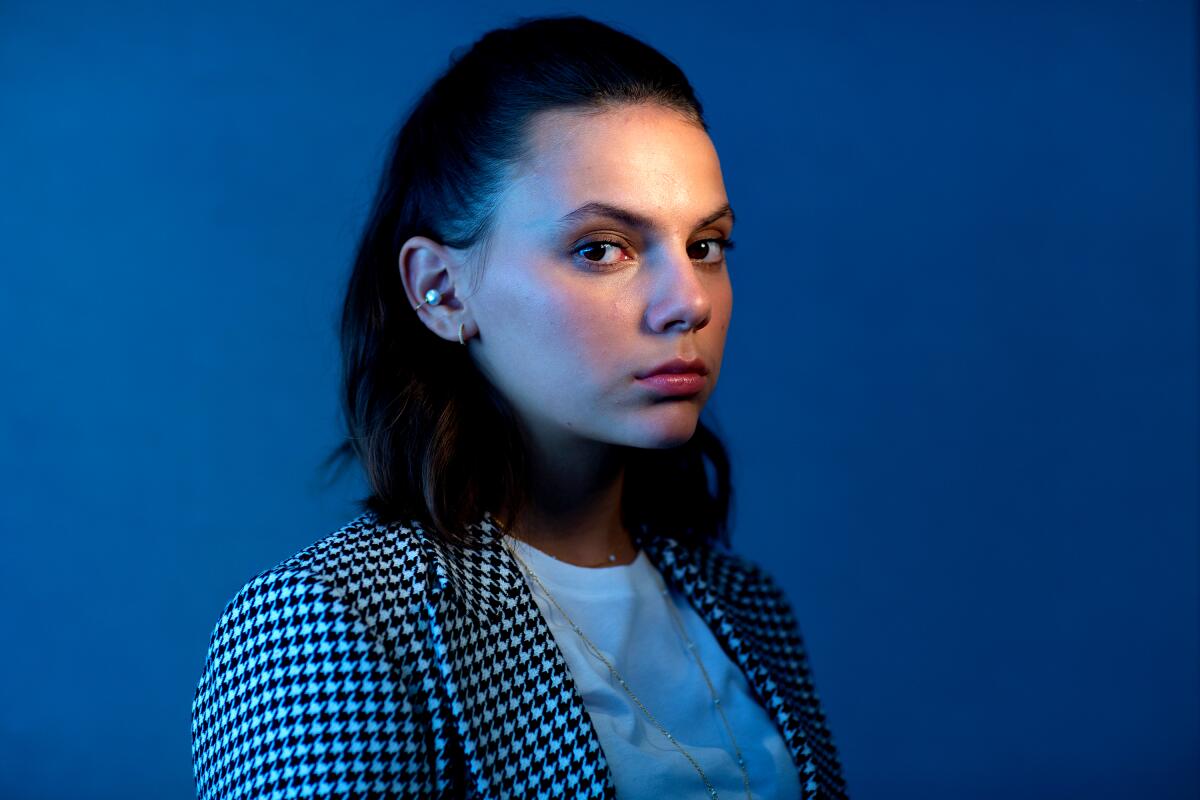 Dafne Keen in front of a blue backdrop.