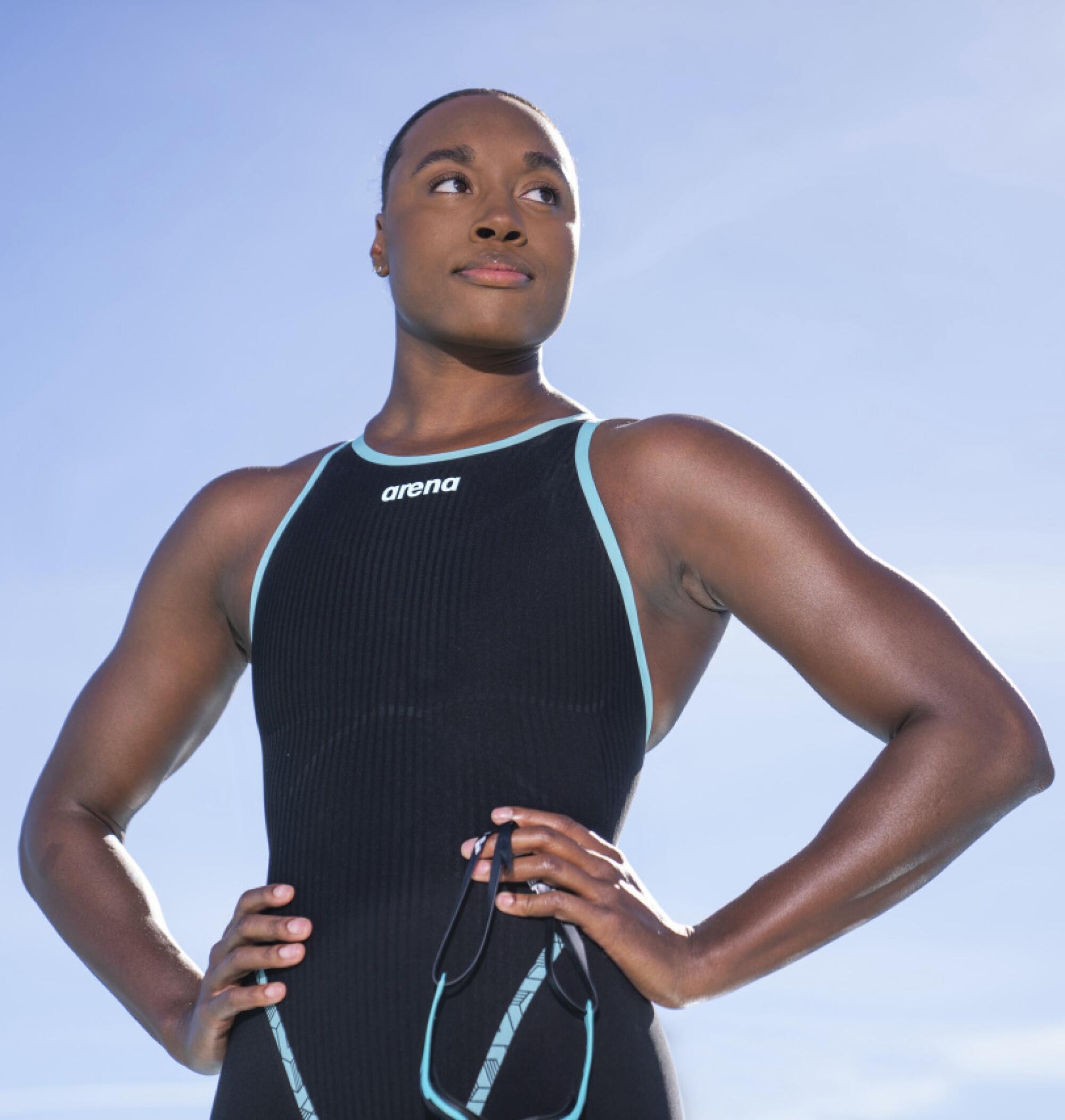 Simone Manuel stands in her swimsuit.