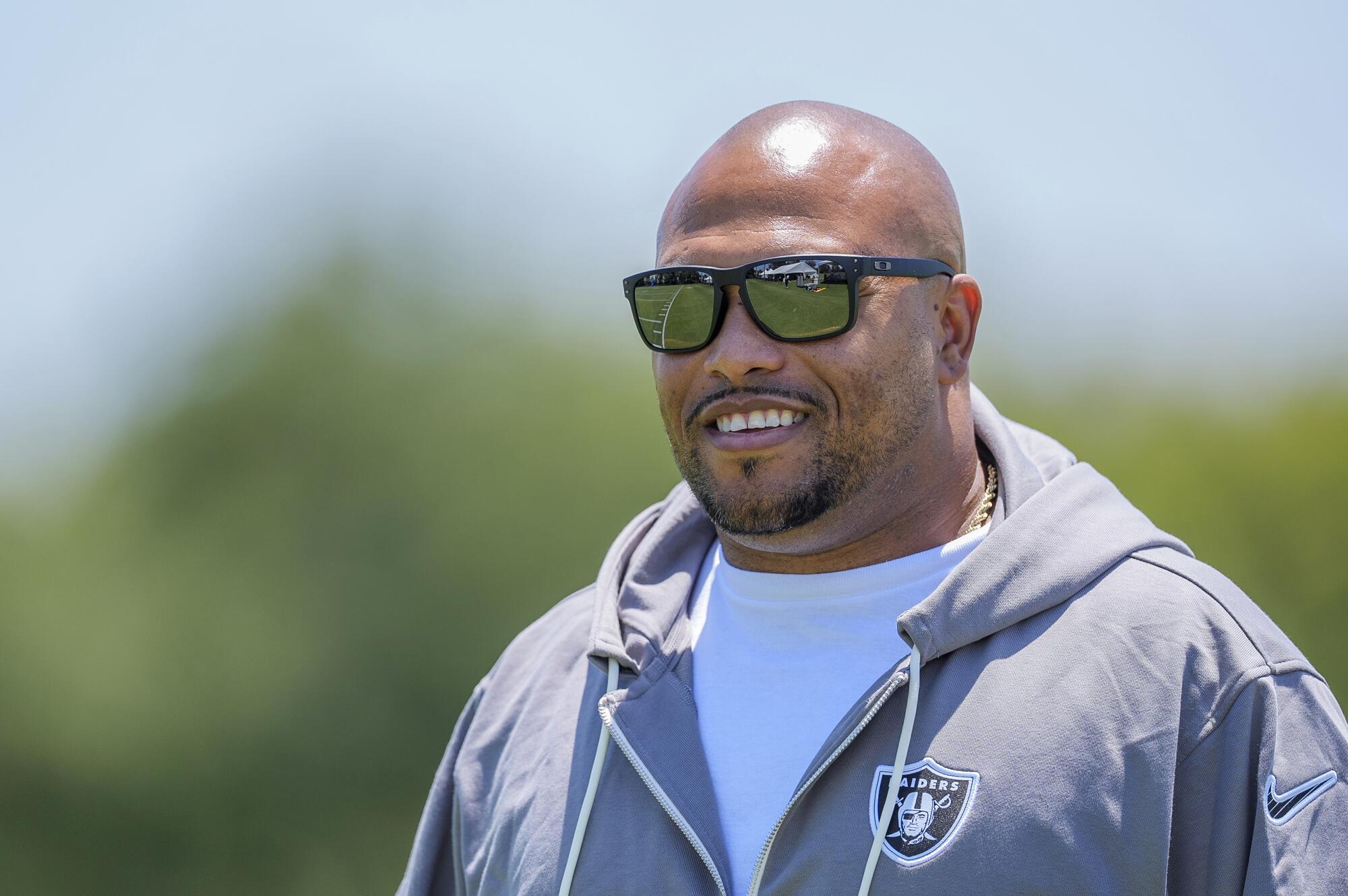 Raiders coach Antonio Pierce wears sunglasses during practice in Costa Mesa.