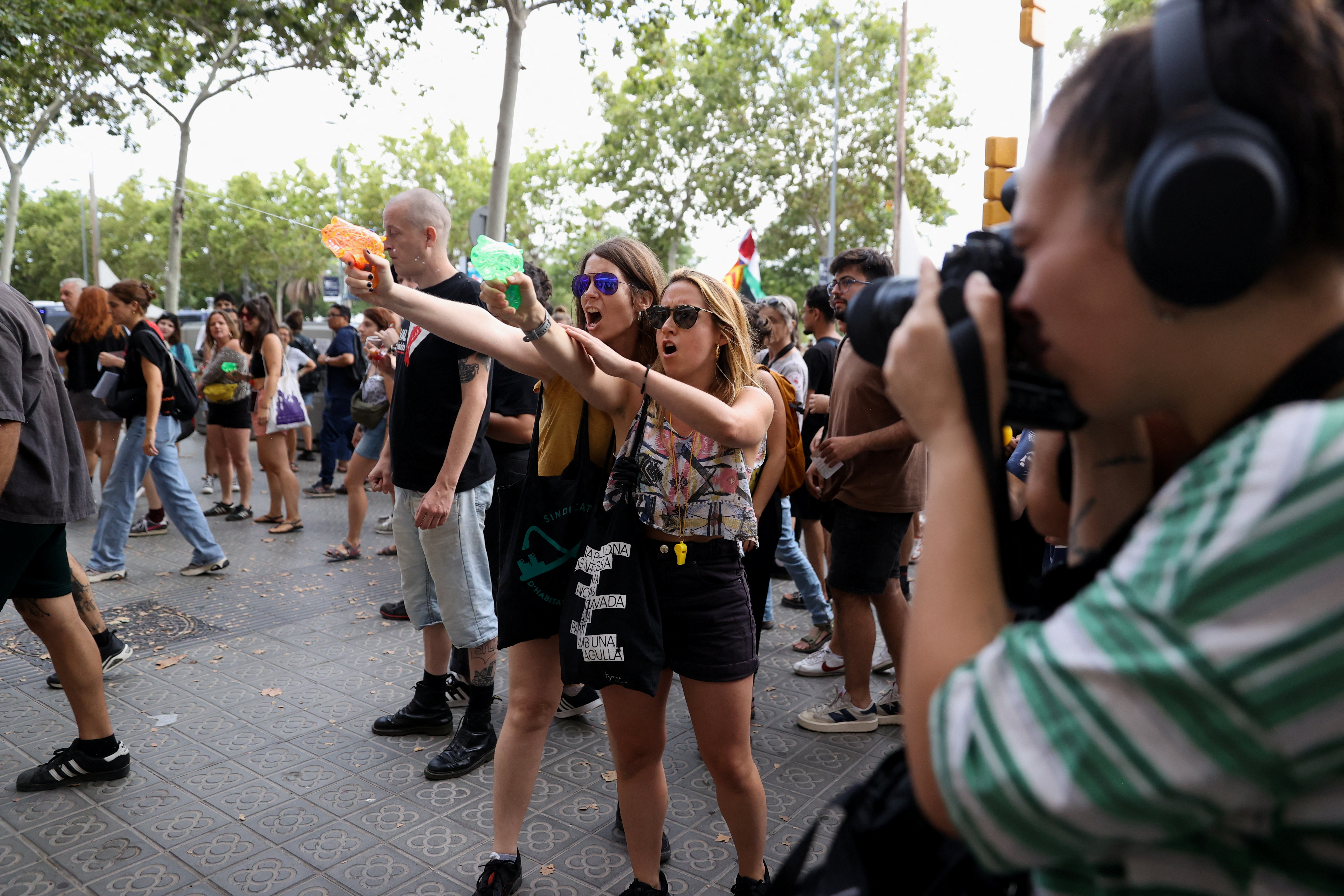 Locals spray tourists with water guns in Barcelona, early July