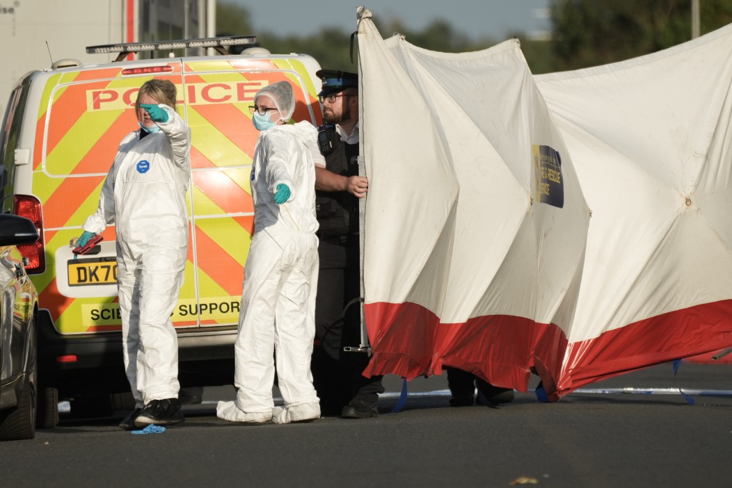 Forensic officers scouring the scene in the evening following the chaos