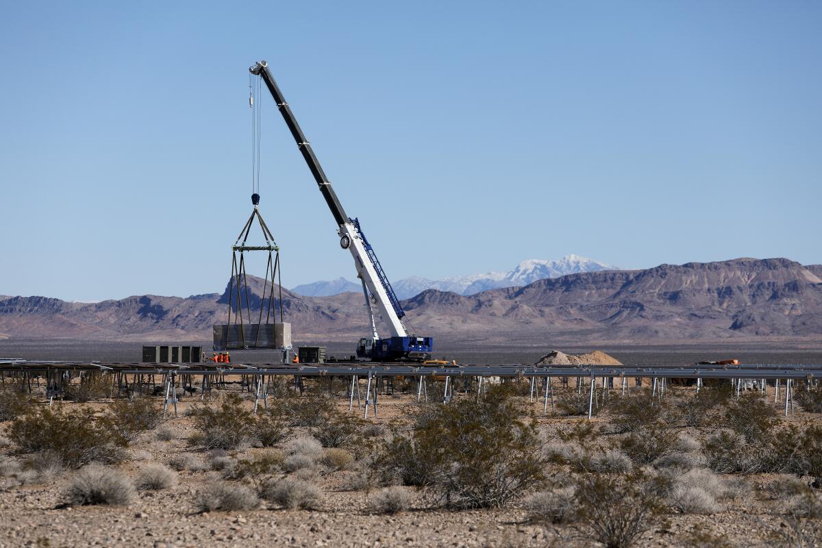 A crane places equipment during construction of the Gemini solar project in Nevada.