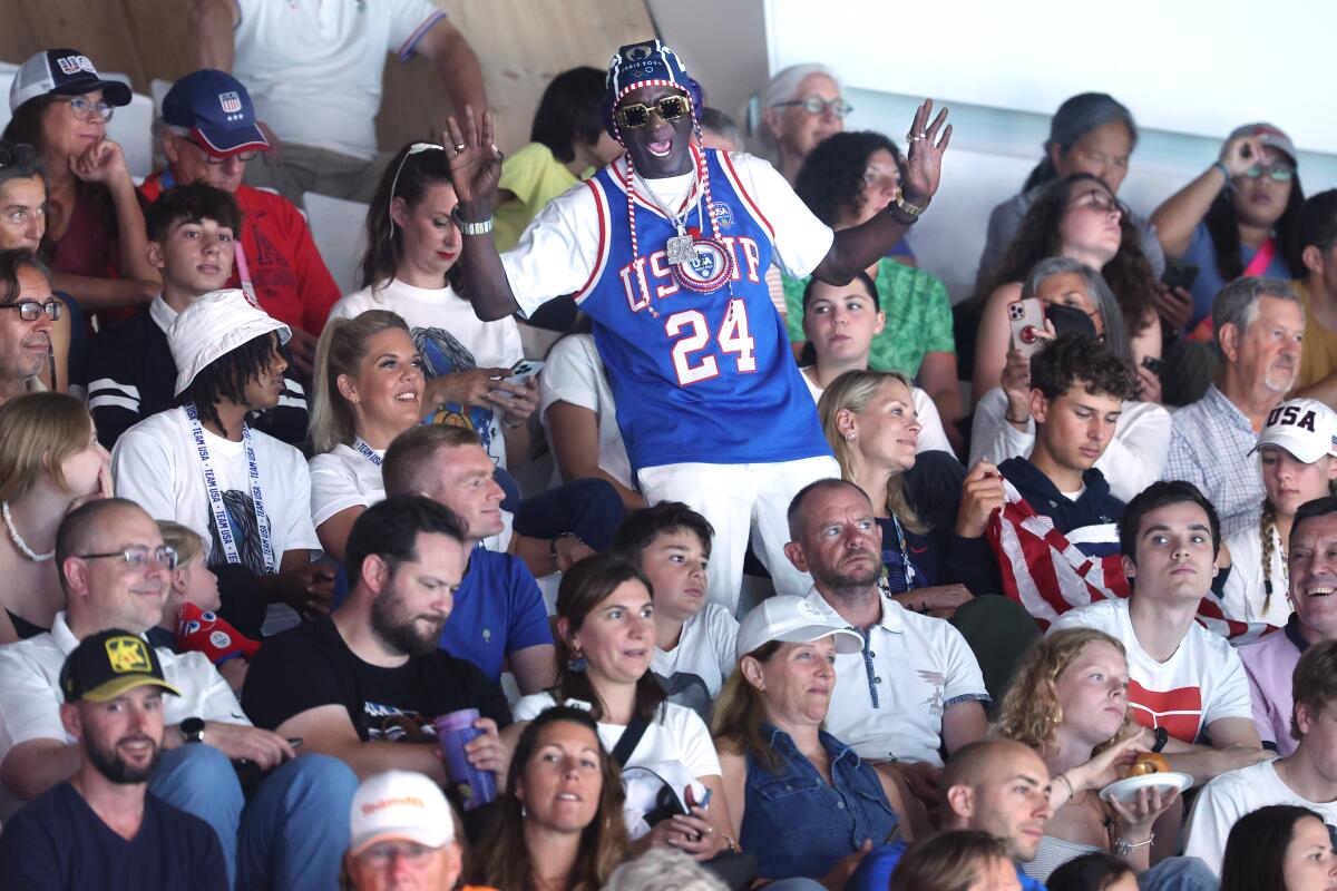 Rapper and official U.S. women's water polo "hypeman" Flavor Flavor cheers during a match.