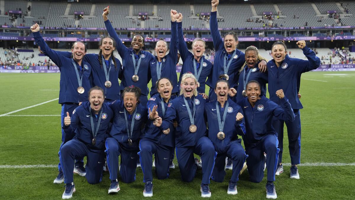 Members of the United States rugby sevens team pose with their bronze medals.