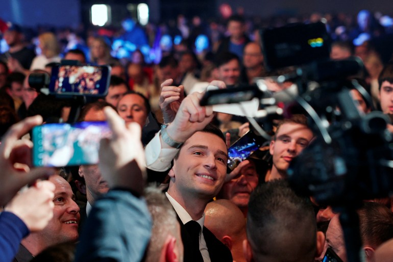 President of the French far-right National Rally (Rassemblement National-RN) party Jordan Bardella takes a selfie with supporters, during a political rally to launch the party's campaign for the European elections, in Marseille, France, March 3, 2024. REUTERS/Gonzalo Fuentes