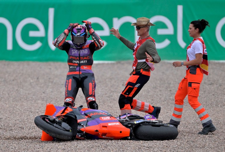 Rider reacts to dropping the bike during the race.