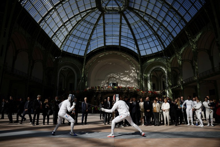 FILE PHOTO: French President Emmanuel Macron attends a demonstration by the French fencing team during his visit to the Grand Palais, 100 days ahead of the Paris 2024 Olympic Games in Paris, France, April 15, 2024. Yoan Valat/Pool via REUTERS/File Photo