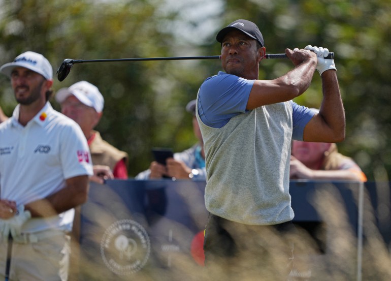 Tiger Woods hits golf shot.