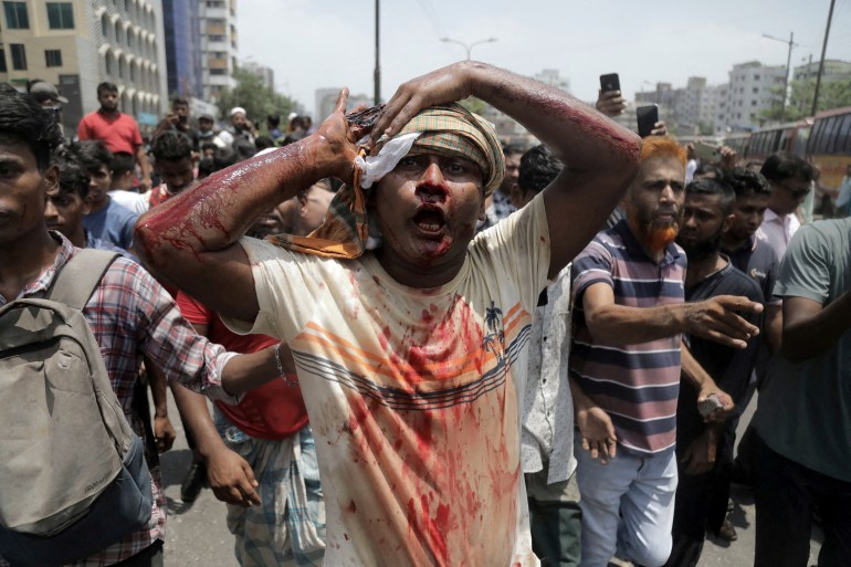 An injured protester is rushed to hospital after a clash with police and Awami League supporters at the Rampura area in Dhaka