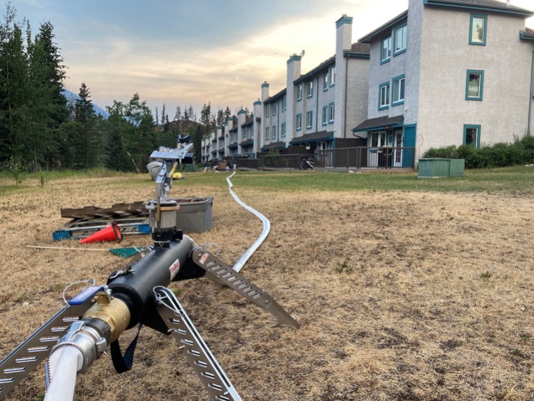 A water hose is seen near a building in Jasper, Canada