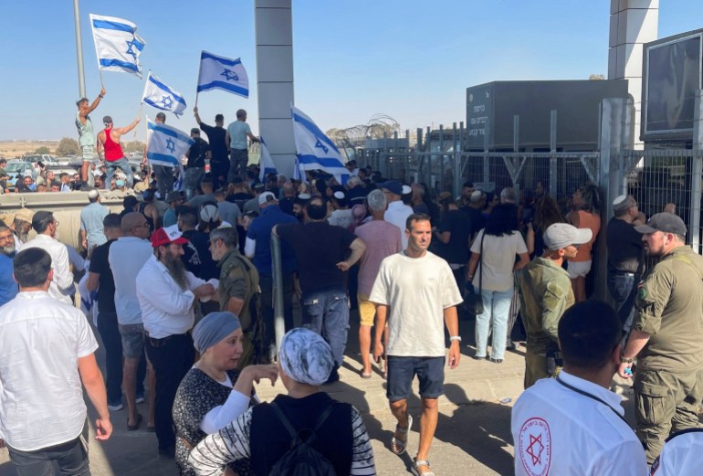 Right-wing protesters wave Israeli flags outside Sde Teiman detention facility