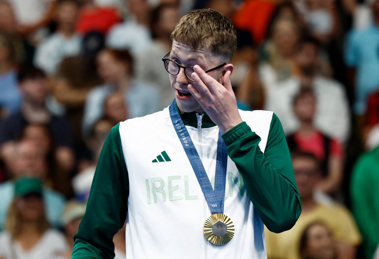 Paris 2024 Olympics - Swimming - Men's 800m Freestyle Victory Ceremony - Paris La Defense Arena, Nanterre, France - July 30, 2024. Gold medallist Daniel Wiffen of Ireland reacts as he celebrates after winning and establishing Olympic record. REUTERS/Clodagh Kilcoyne