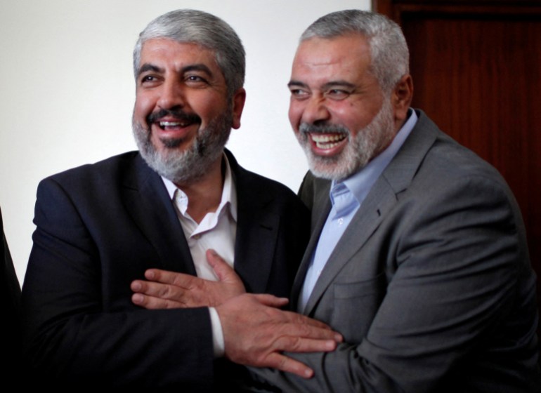 Hamas chief Khaled Meshaal hugs senior Hamas leader Ismail Haniyeh before leaving Gaza 