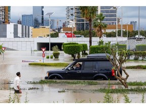 A motorist waits while attempting to navigate floodwaters in Dubai, on April 16.