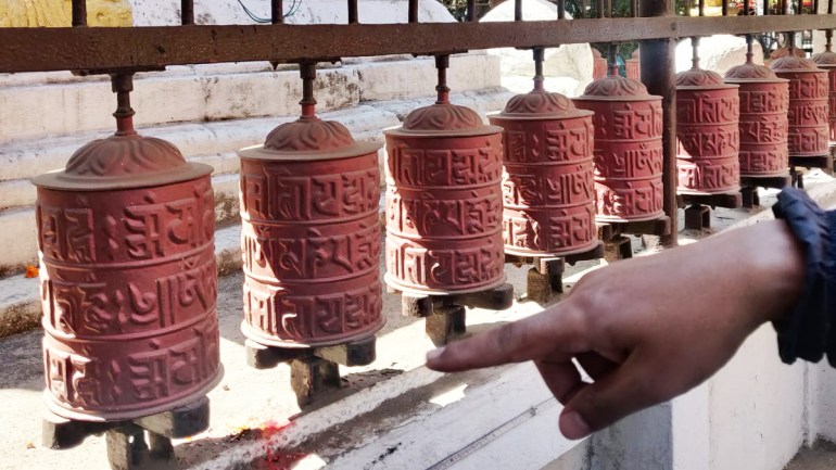 Anand Maharjan shows prayers wheels around Kathmandu that have Ranjana Lipi