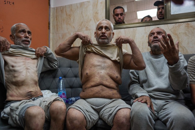 Palestinian men who had been detained by Israeli forces arrive for a check-up at Al-Aqsa Hospital in Deir al-Balah, central Gaza Strip, July 1 [Bashar Taleb/AFP]