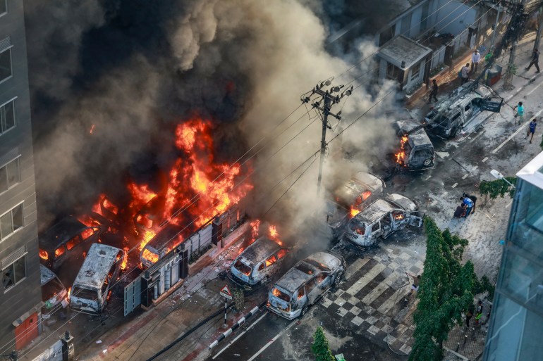 Smoke rises from the burning vehicles after protesters set them on fire near the Disaster Management Directorate office, during the ongoing anti-quota protest in Dhaka 