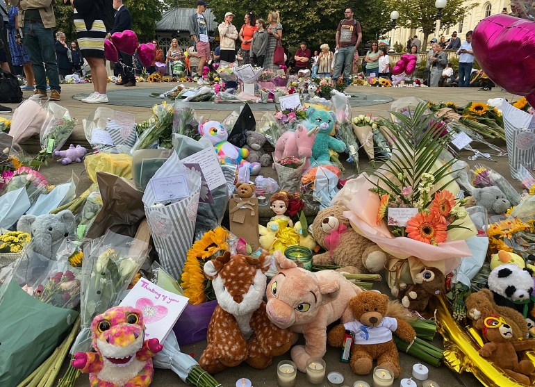 Piles of flowers and soft toys laid at a vigil in Southport following Monday's attack.